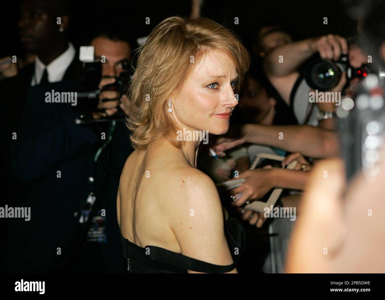 Actress Jodie Foster poses for fans as she arrives at the premiere of