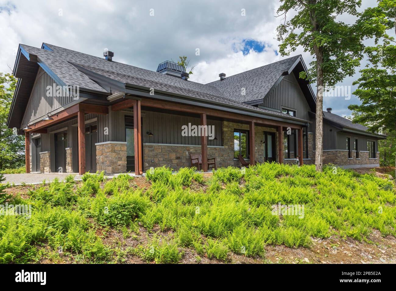 Cut stone and charcoal wood plank with black trim hybrid timber frame ...