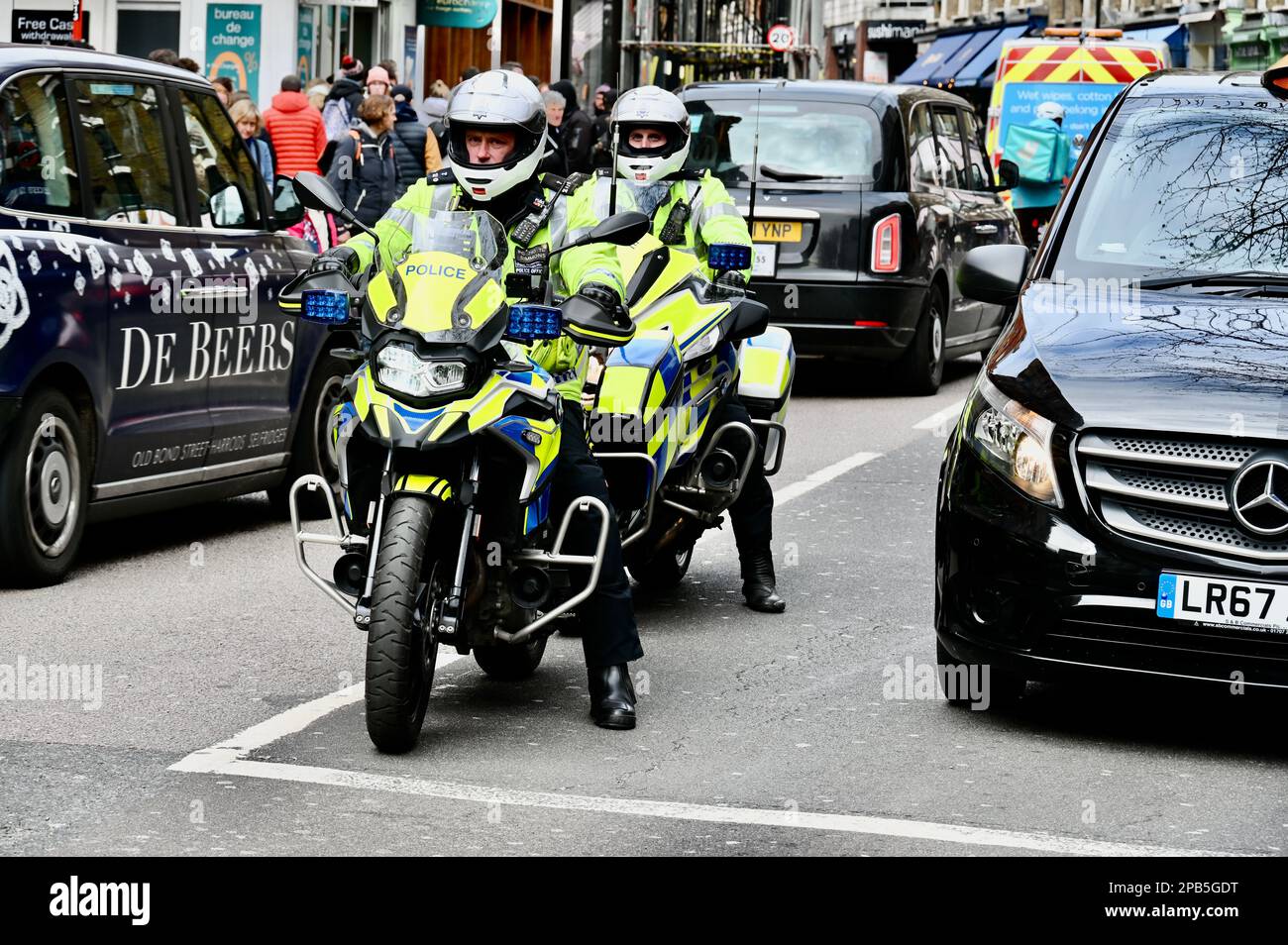 Police motorcyclists, Charing Cross Road, Westminster, London, UK Stock