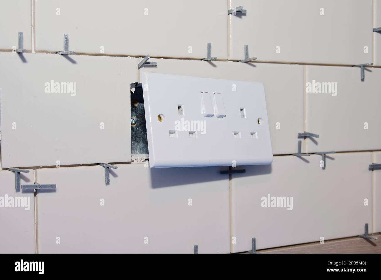 New tile installation in kitchen with electrical sockets removed Stock