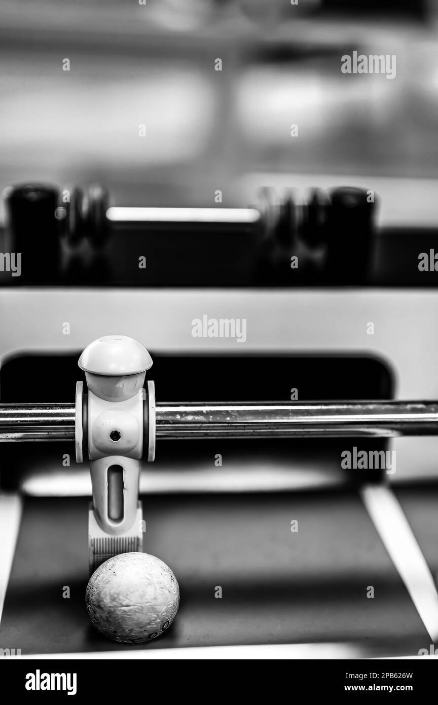 Selective focus on a foosball goalie blocking the ball insider the box. Stock Photo