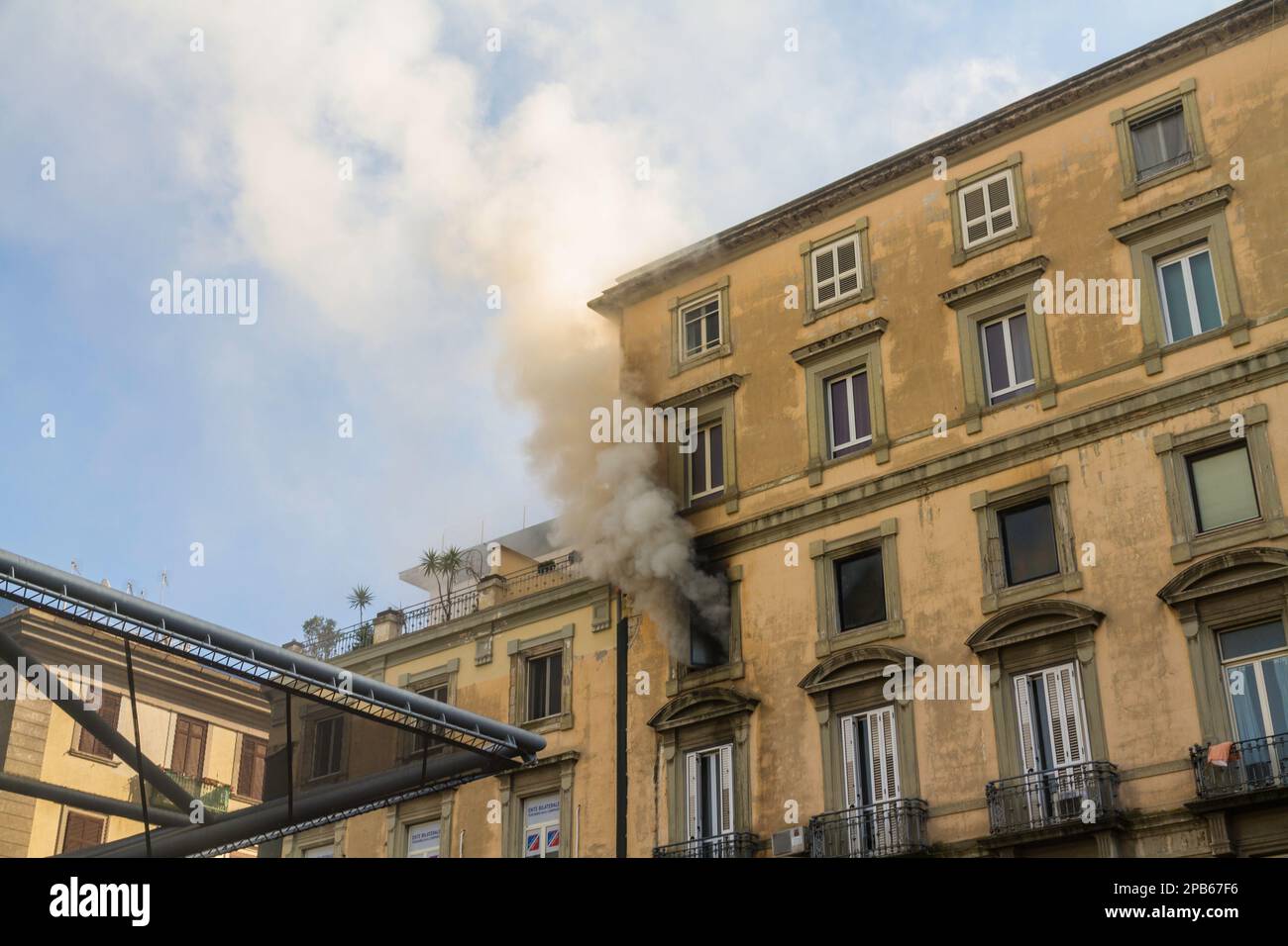 Naples, Italy - February 15th 2023 - Domestic apartment fire with smoke billowing from window. Garibaldi Square, Naples, Italy, landscape, wide angle Stock Photo