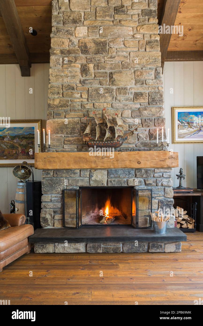 Natural cut stone wood burning fireplace in living room inside hybrid