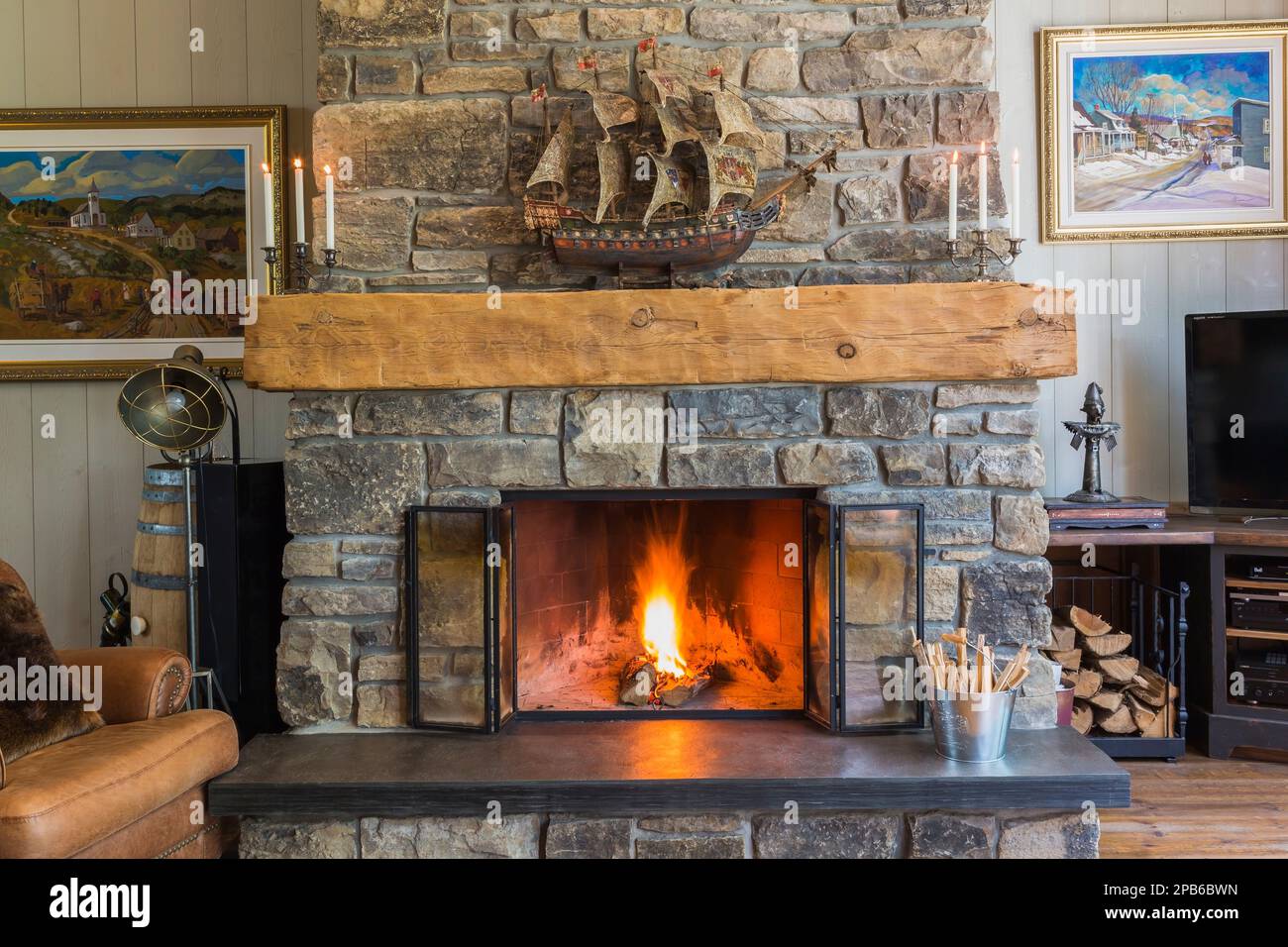 Natural cut stone wood burning fireplace in living room inside hybrid