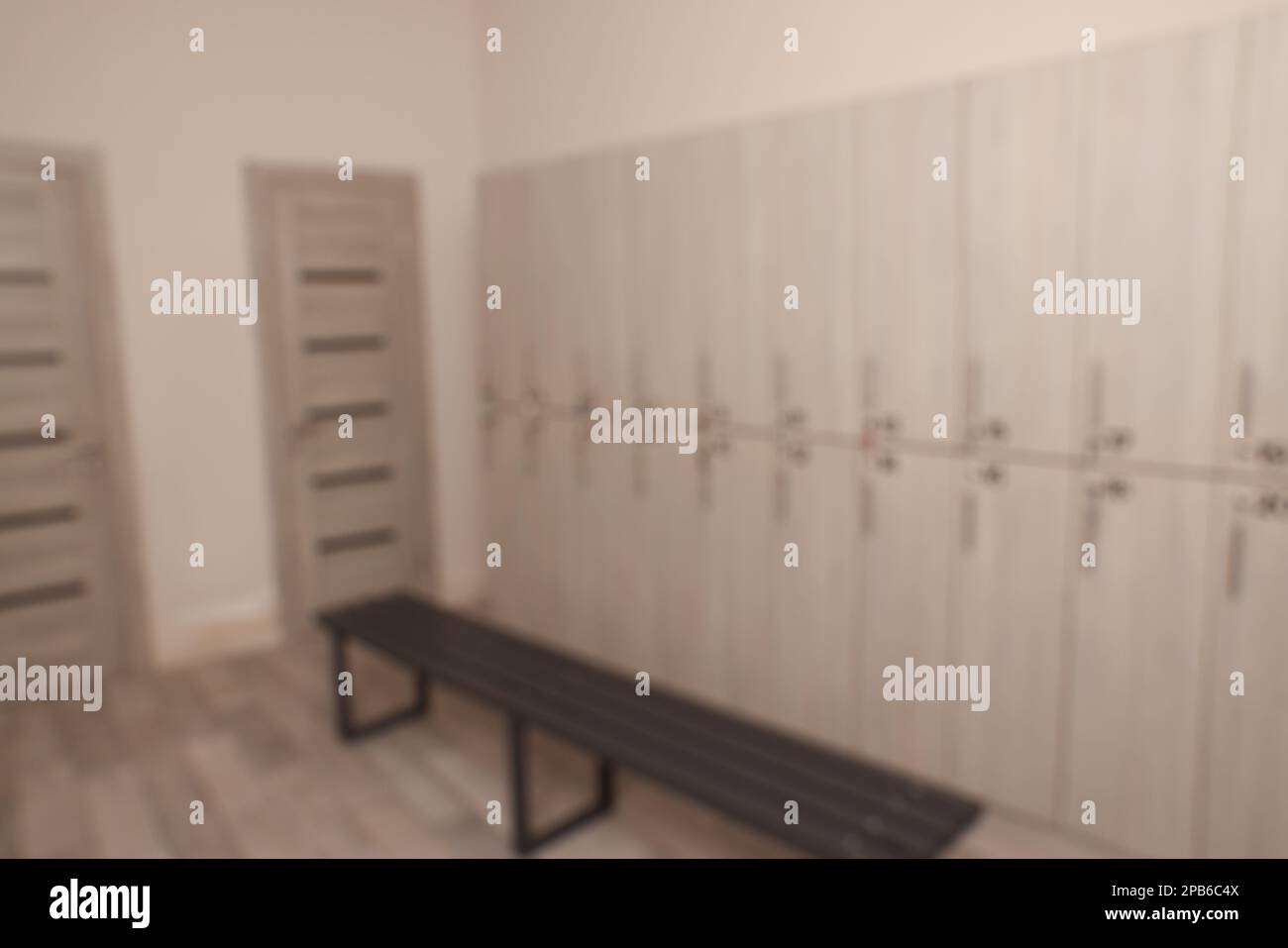 Blurred view of changing room with bench and lockers Stock Photo Alamy