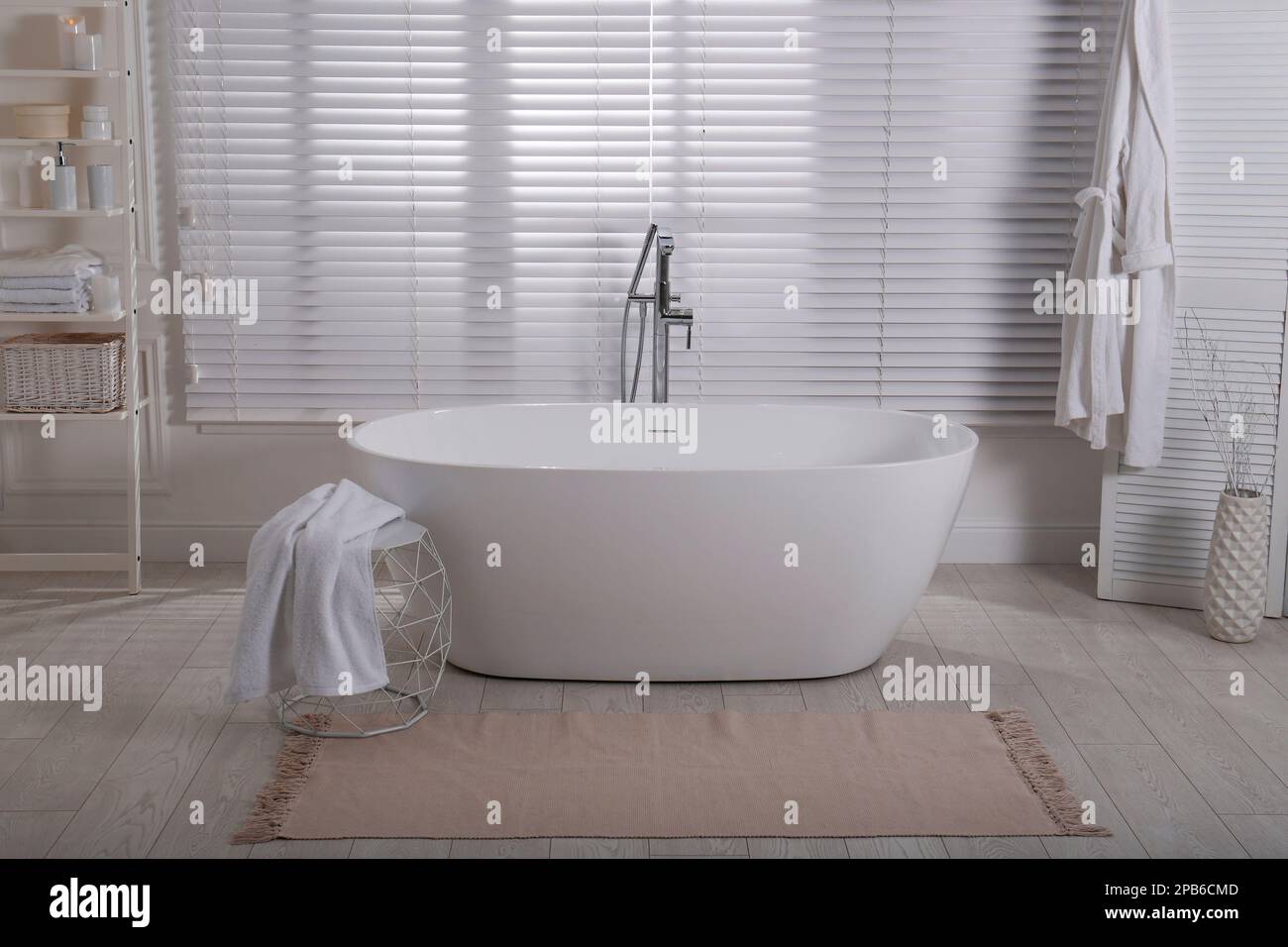 Minimal bathroom interior with modern white tub Stock Photo - Alamy