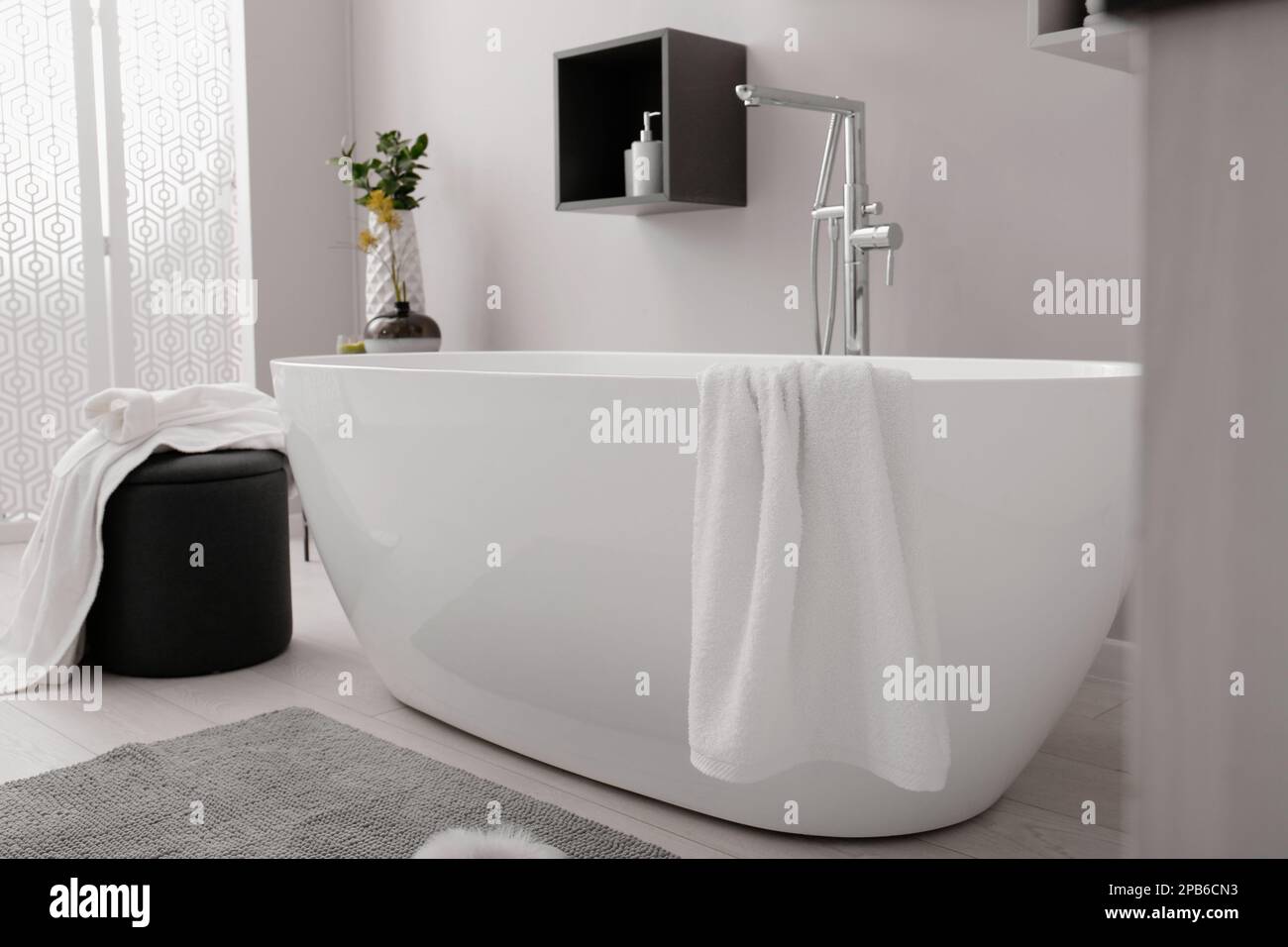 Stylish bathroom interior with modern white tub Stock Photo - Alamy
