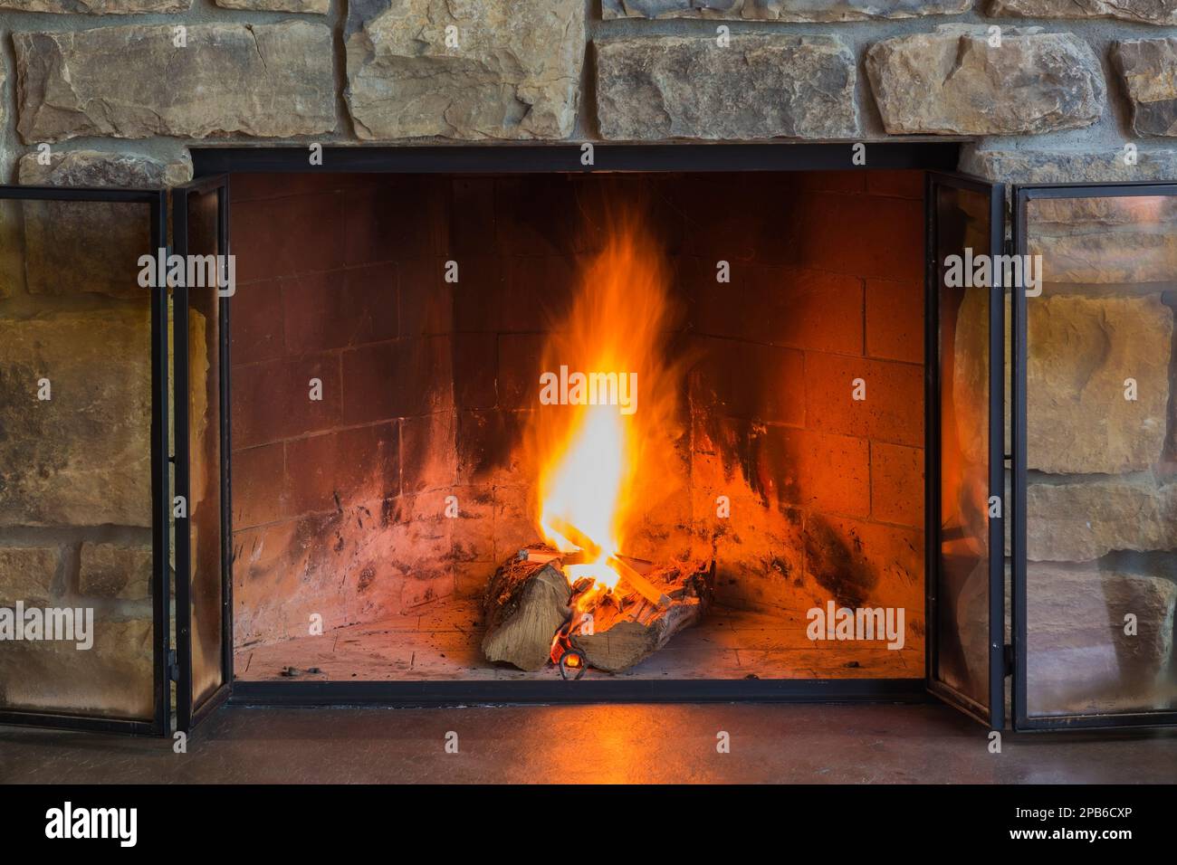 Natural cut stone wood burning fireplace in living room inside hybrid