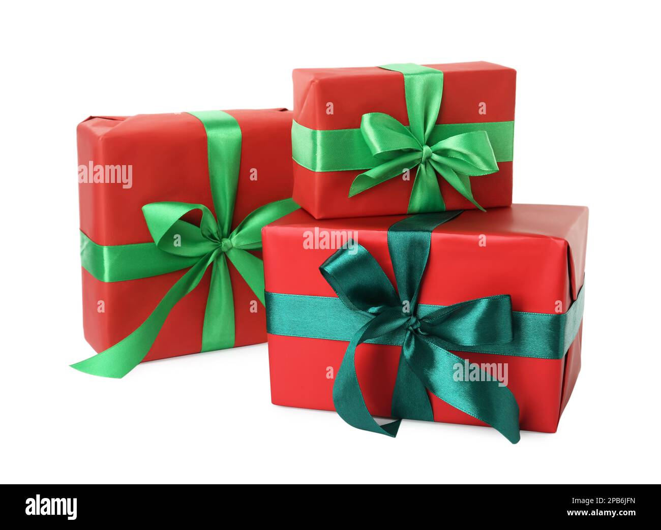 Red gift boxes with green bows on white background Stock Photo - Alamy