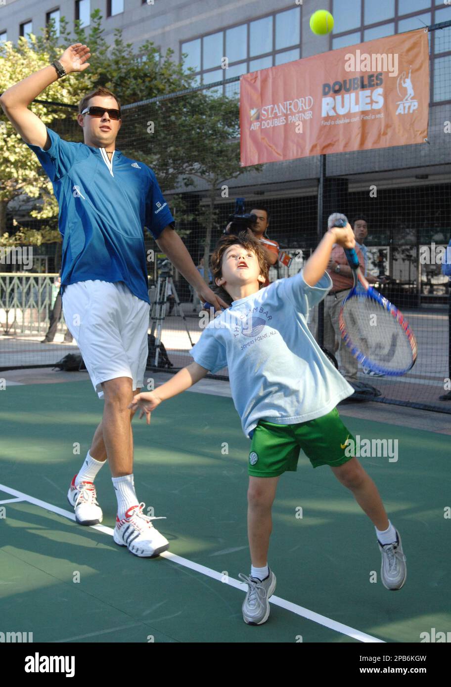 In this photo released by the Association of Tennis Professionals (ATP),  Danny Ritz, right, 6, of Philadelphia, Pa., serves as doubles partner to Bob  Bryan, left, half of the number one ranked