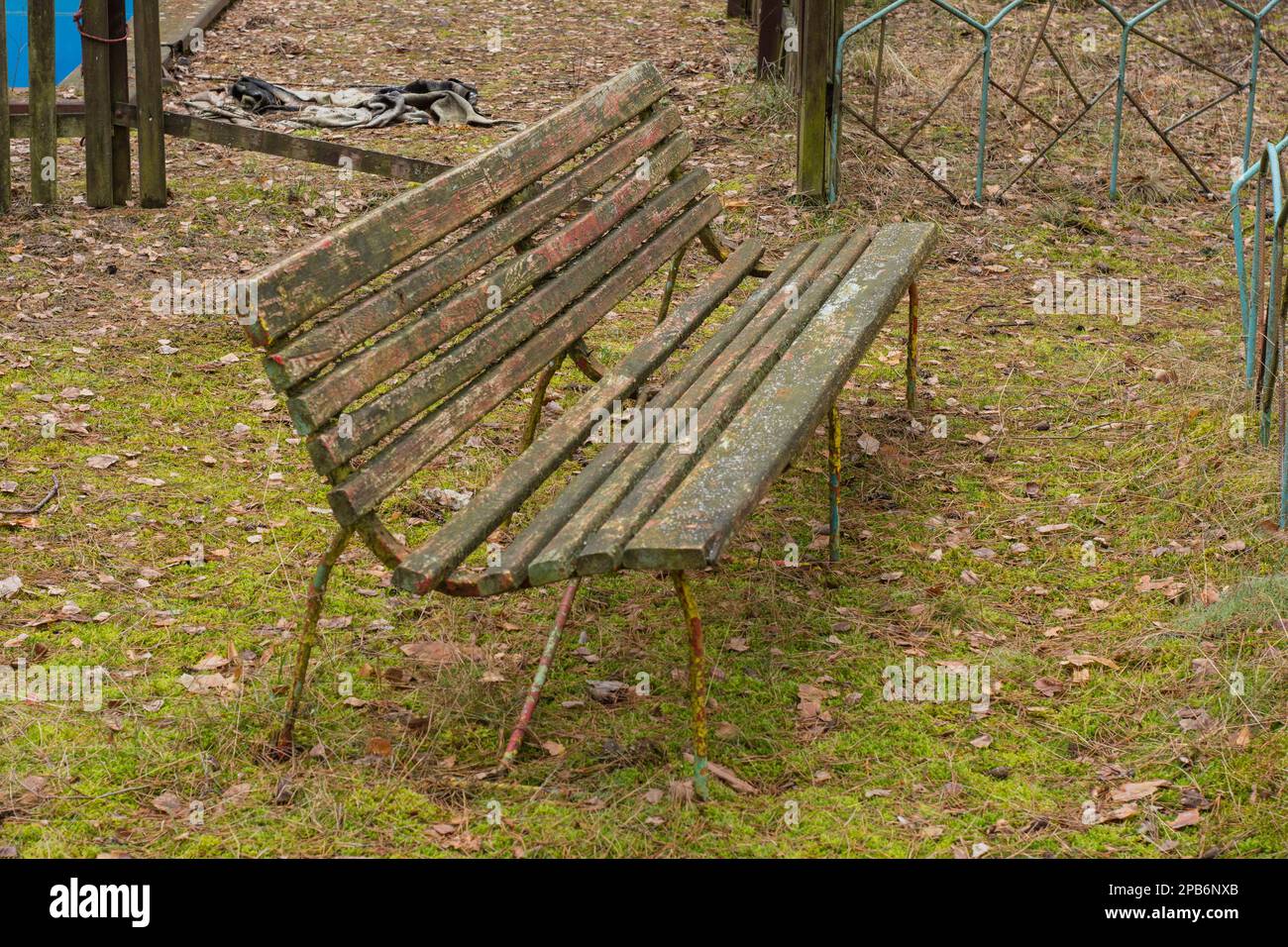 A dilapidated and forgotten bench in an abandoned resort on a gloomy ...