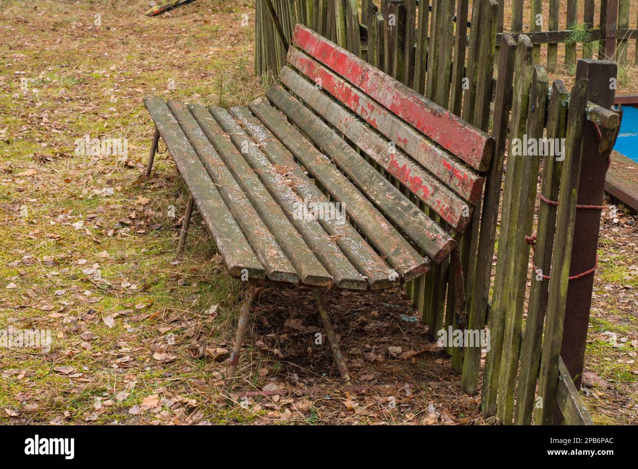 A dilapidated and forgotten bench in an abandoned resort on a gloomy ...
