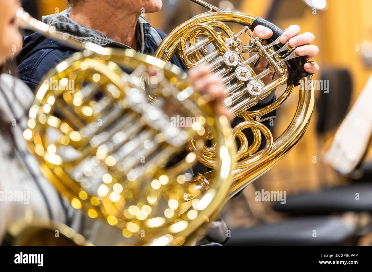 French horn instrument, hands playing horn player in philharmonic