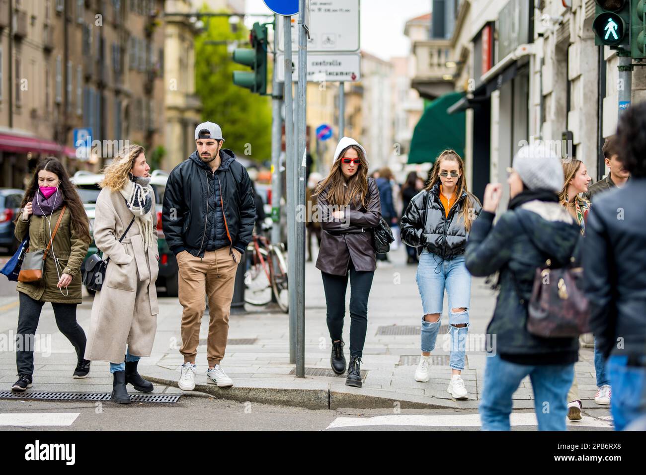 MILAN, ITALY - APRIL 2022: Tourists and locals walking down busy streets in the center of Milan, a metropolis in Italy's northern Lombardy region. Mil Stock Photo