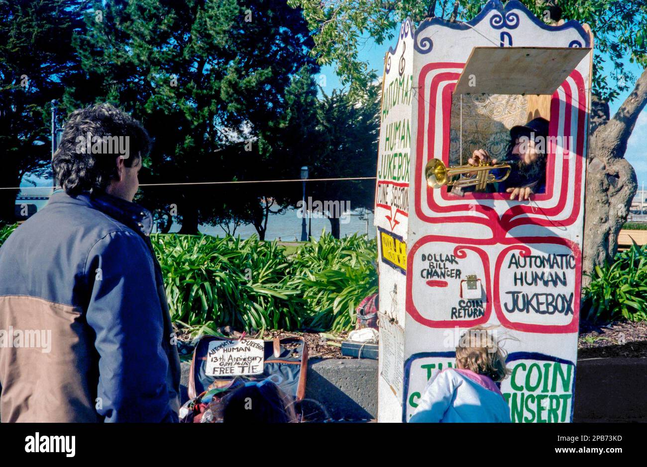 The Automatic Human Jukebox, American musician Grimes Poznikov playing a trumpet for tourists on Fisherman’s Wharf in San Francisco, California 1986. Stock Photo
