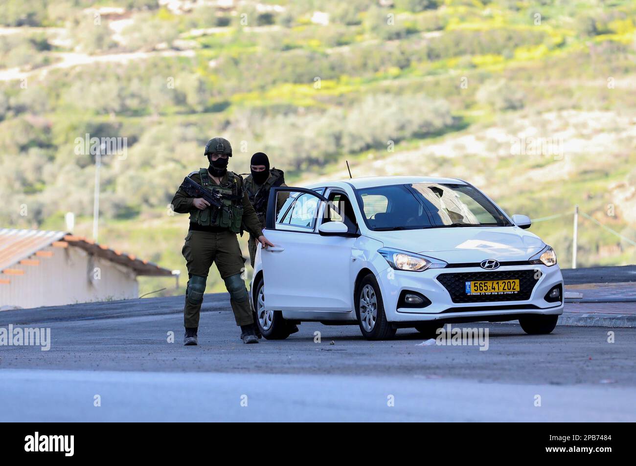 Surra, West Bank, Palestine. 12th Mar, 2023. Nablus, West Bank, Palestine. 12 March 2023. Israeli troops at the site where 3 Palestinian young men were killed on Sunday morning west of the West Bank city of Nablus. On Sunday the Israeli army announced the death of 3 Palestinian militants and the arrest of a fourth as they opened fire during a 'pre-emptive operation'' to neutralise three Palestinian gunmen in a car near the junction of the village of Surra, west of Nablus. After the operation the Israeli troops withheld the bodies of the three men and confiscated the vehicle. No Israeli casu Stock Photo