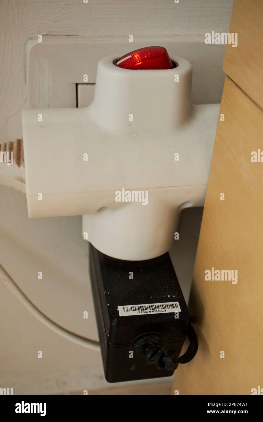 european 3 way plug extension socket plugged in to wall socket in spain