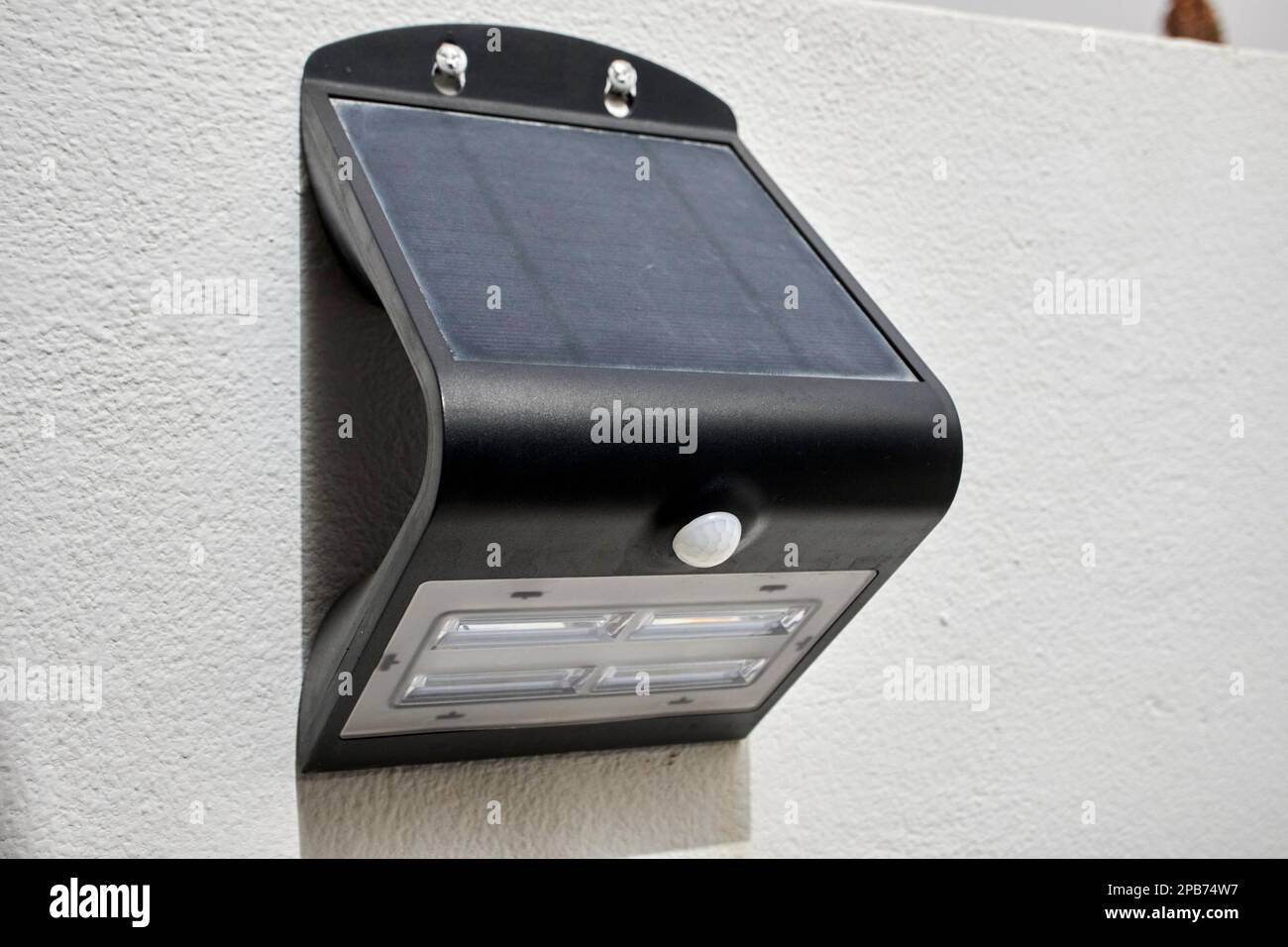 solar powered motion activated outdoor security light on a wall in a property in Lanzarote, Canary Islands, Spain Stock Photo