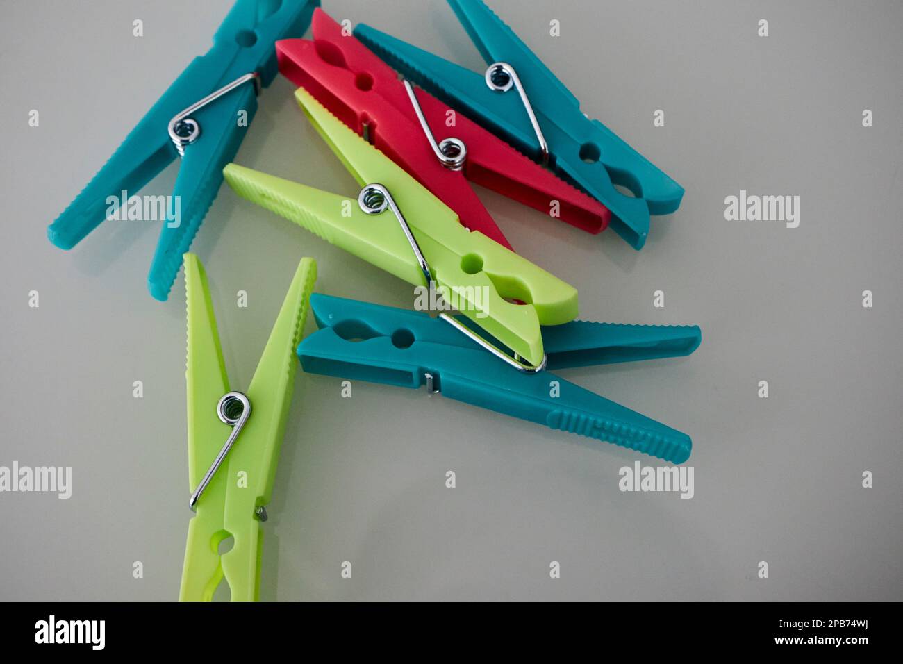 coloured plastic clothes pegs pins lying on a table in Lanzarote, Canary Islands, Spain Stock Photo
