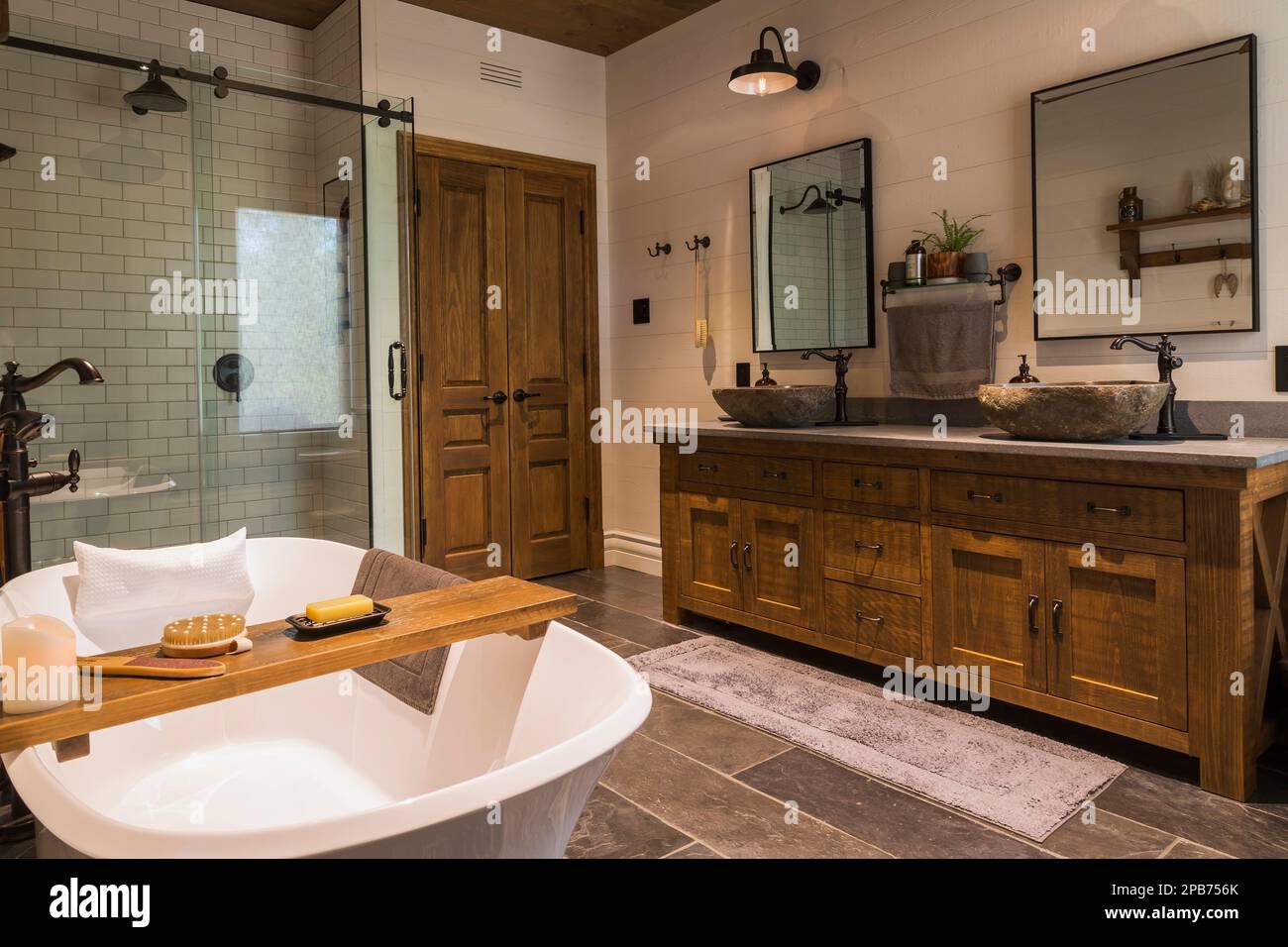 White freestanding soaking tub, clear glass and ceramic shower stall