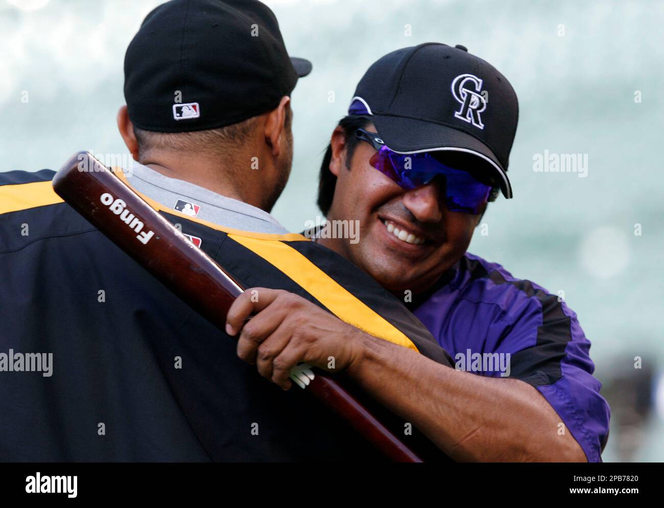 Vinny Castilla, left, special assistant to the general manager of the  Colorado Rockies, greets Chicago Cubs right fielder Carlos Gonzalez before  a baseball game Monday, June 10, 2019, in Denver. Gonzalez was