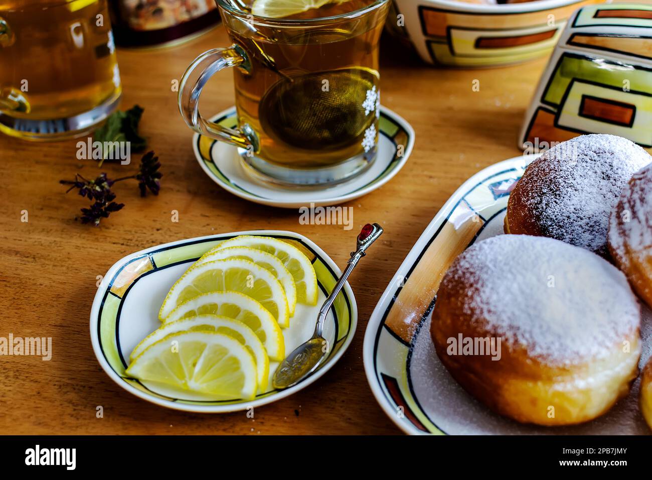 Doughnut dusted with powdered sugar for breakfast with herbal tea Stock