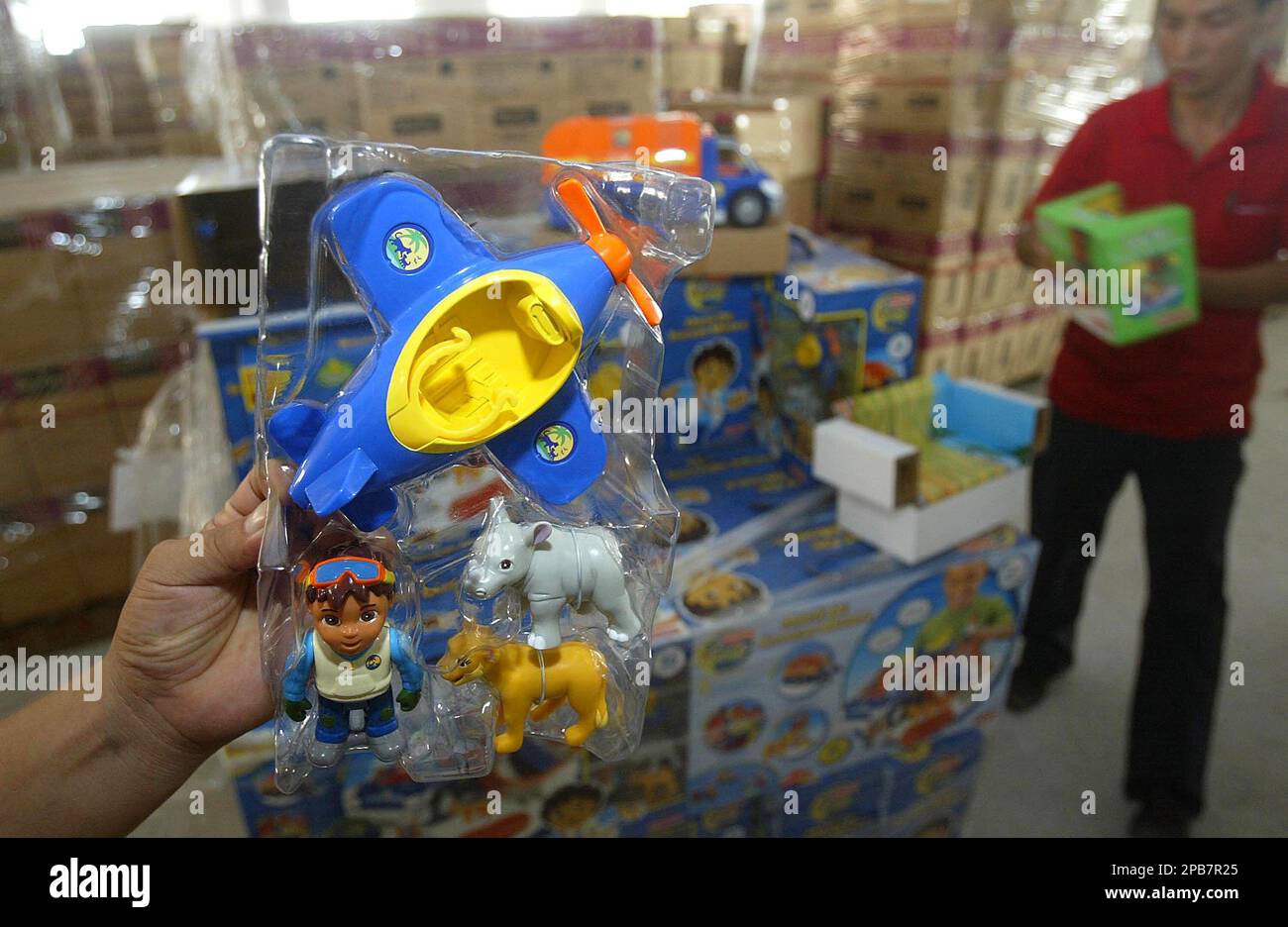 Workers display toys containing excessive lead levels at the factory of Lee Der Industrial Co. Ltd., in Foshan, in south China's Guangdong province, Sunday, Aug. 12 2007. Lee Der co-owner, Cheung Shu-hung, committed suicide on Aug. 11, following a decision by the General Administration for Quality Supervision, Inspection and Quarantine to ban exports from the factory. US company Mattel Inc. had earlier recalled 967,000 toys made by Lee Der because they were made with paint with excessive amounts of lead. (AP Photo/Color China Photo) ** CHINA OUT ** Stock Photo