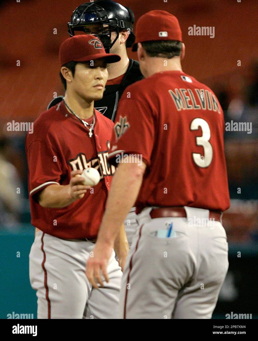 Arizona Diamondbacks pitcher ByungHyun Kim, left, of South Korea, is taken out of the game by