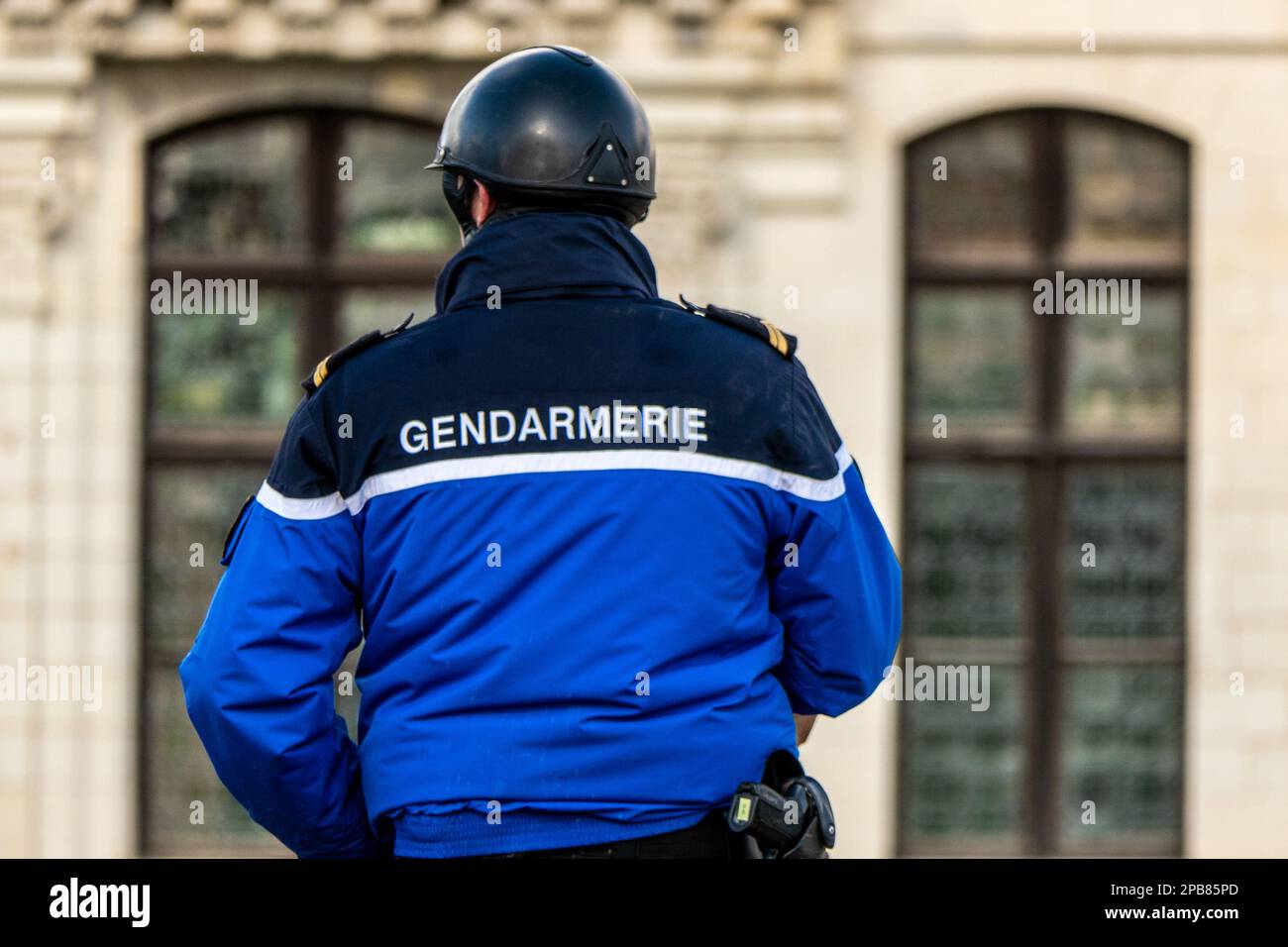 Chambord, France. February 25, 2023. French gendarme on a horse seen from behind with inscription gendarme on his jacket Stock Photo