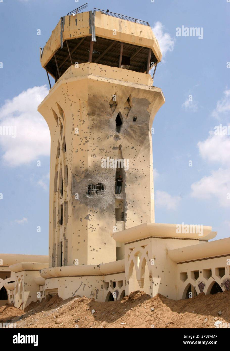 A Palestinian looks out from the destroyed control tower of Yasser