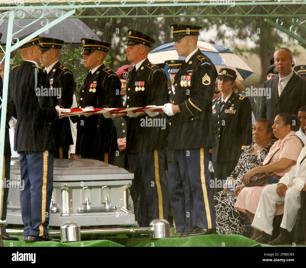 Iris Santiago, the mother of Army Capt. Maria Ines Ortiz, second from ...