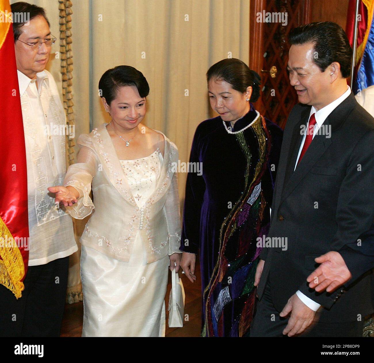 Philippine President Gloria Macapagal Arroyo, second from left, gestures to  Vietnam Prime Minister Nguyen Tan Dung, right, and wife Madame Kien during  his visit at the Malacanang presidential palace in Manila on