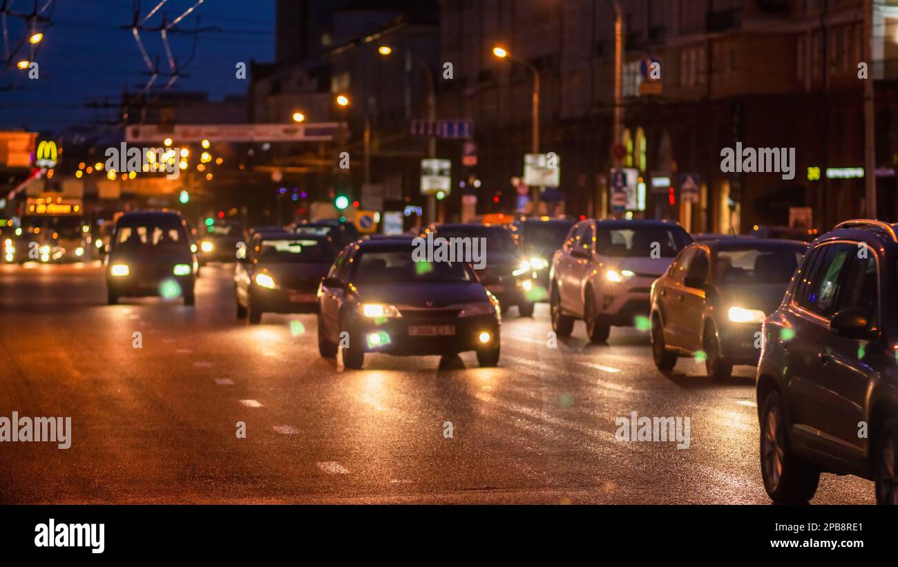 Minsk, Belarus - December 13, 2017: The lights of evening traffic in the city. Lights of cars, storefronts and streetlights. Stock Photo