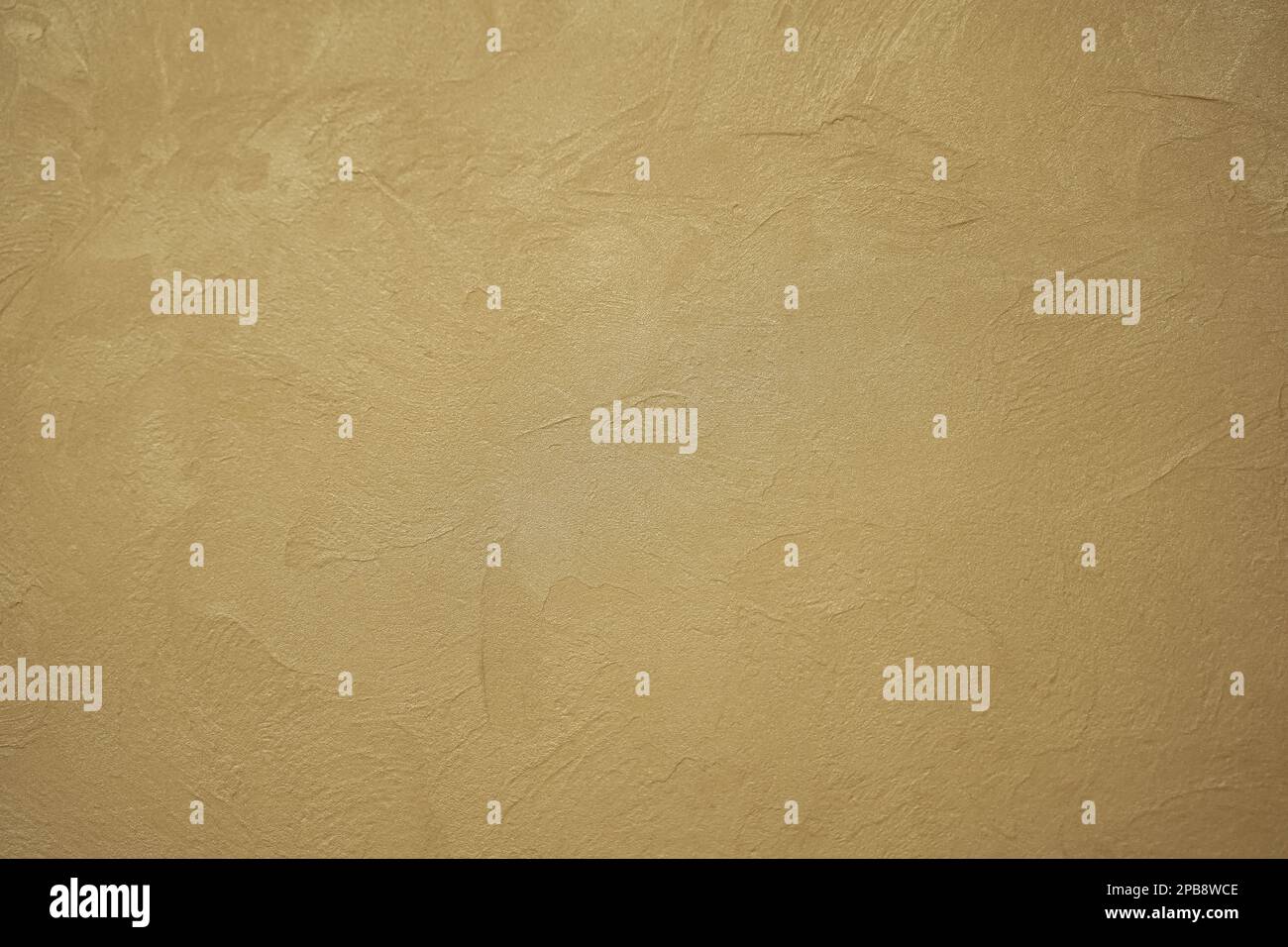 Abstract gold background with plaster texture on wall. Back focus blurred Stock Photo
