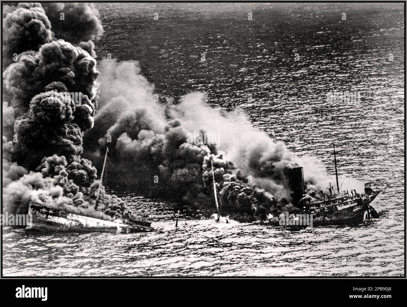 WW2 Battle of The Atlantic Nazi Submarine Torpedo. Allied tanker Dixie Arrow torpedoed in Atlantic Ocean by Nazi German submarine. Ship crumbling amidship under heat of fire, settles toward bottom of ocean, 26 March 1942 World War II Atlantic Battle Stock Photo