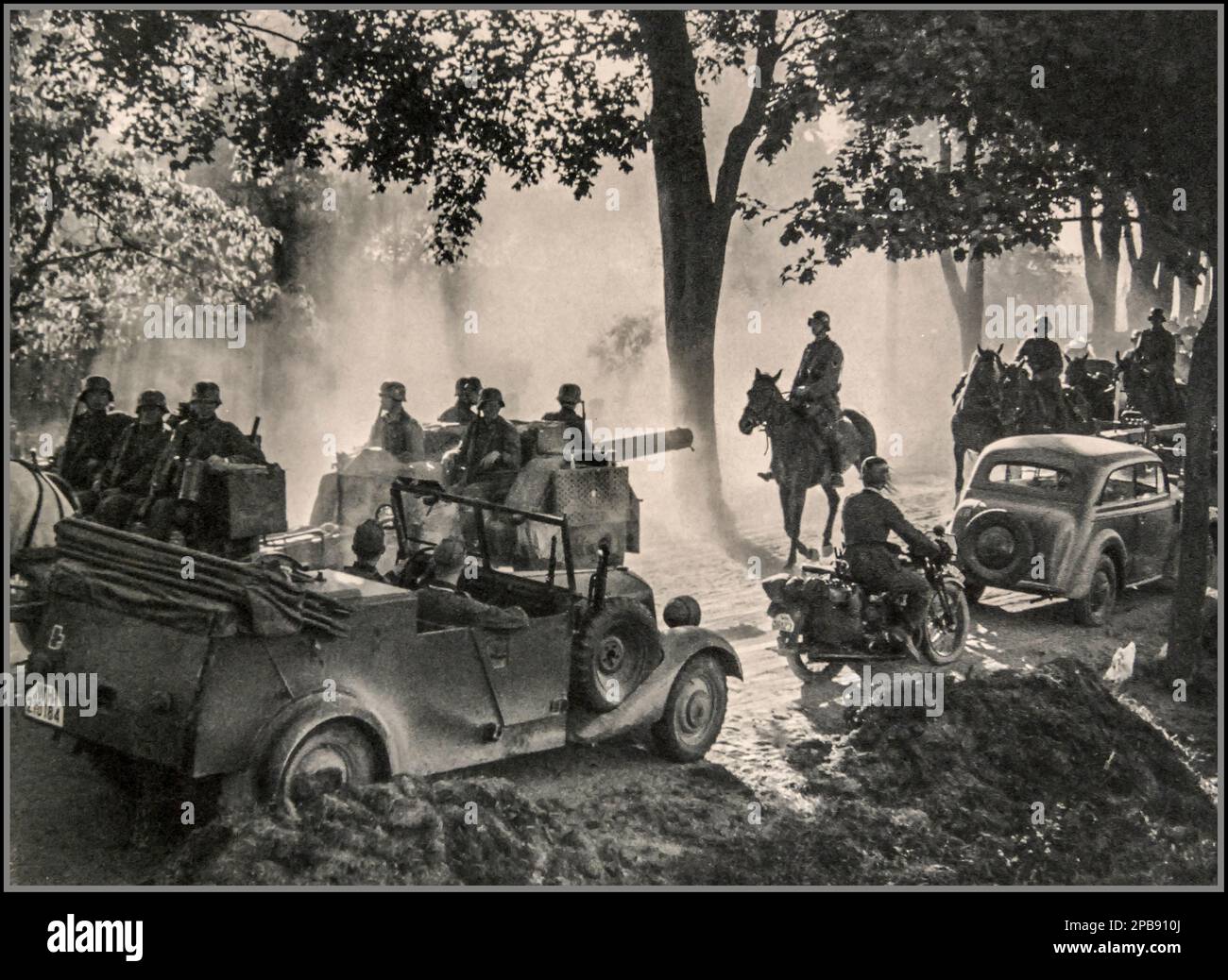 Poland WW2 1939 Nazi Germany occupation of Poland with staff cars Wehrmacht soldiers on horseback, motorcycles, mobile howitzer vehicle, World War II Second World War Remarkable war 'tableau' image by war reporter Utecht Stock Photo