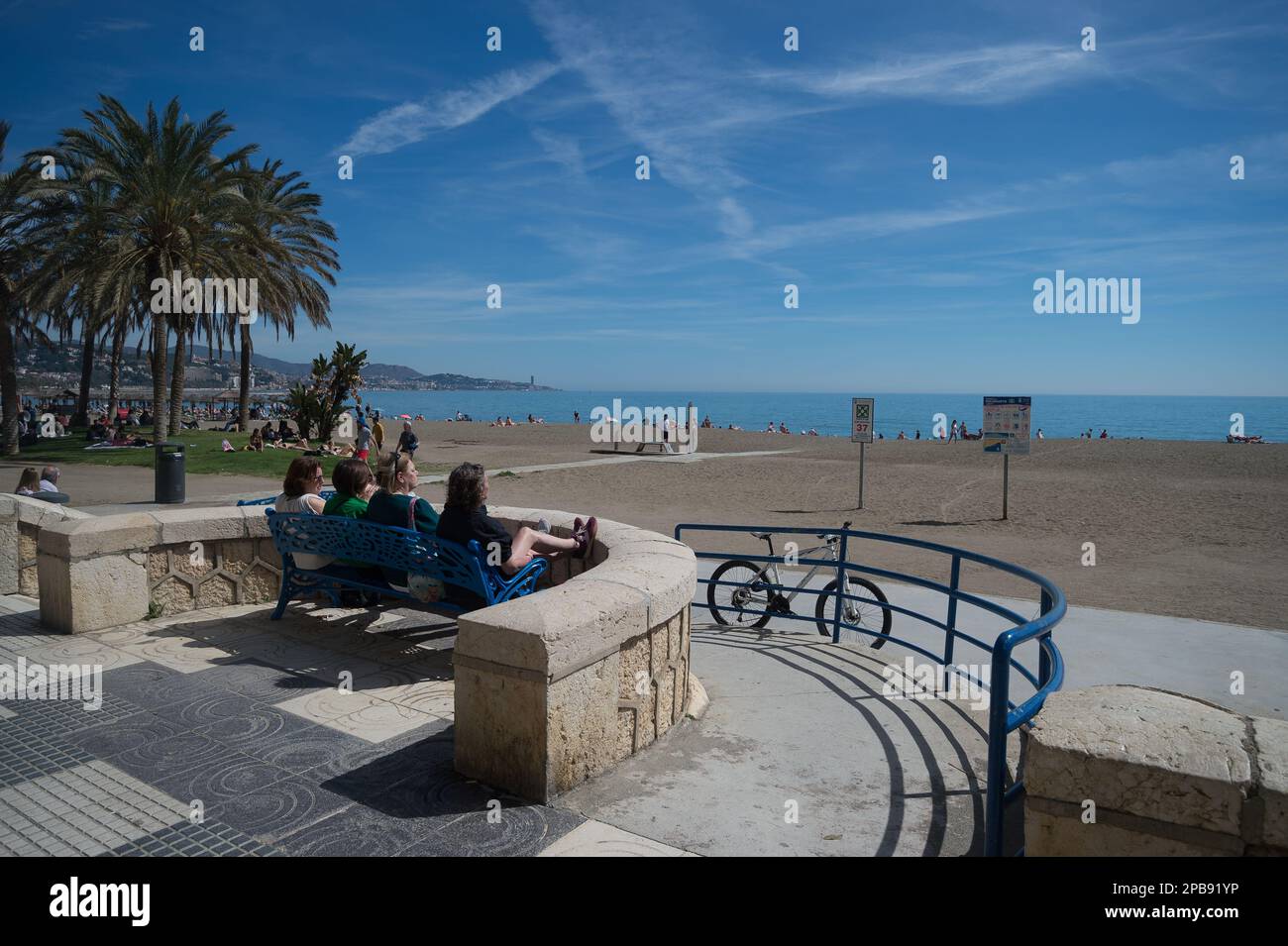 Malaga, Spain. 12th Mar, 2023. People are seen sitting on a bench at