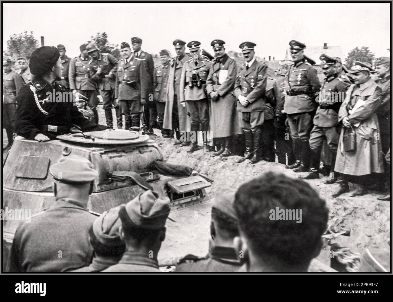 POLAND NAZI OCCUPATION INVASION Adolf Hitler's visit to the 19th armored corps of General Heinz Guderian At the beginning of the Second World War, Guderian led an armoured corps in the Invasion of Poland. Parade of troops. Hitler (4th from the right) watches a passing Panzer Tank Commander in his 'PzKpfw I' tank. Also visible: General Heinz Guderian (5th from the right) and Heinrich Himmler (7th from the right) Depicted People Heinz Guderian, Heinrich Himmler, Adolf Hitler Field Marshall Wilhelm Keitel Date September 1939 Stock Photo