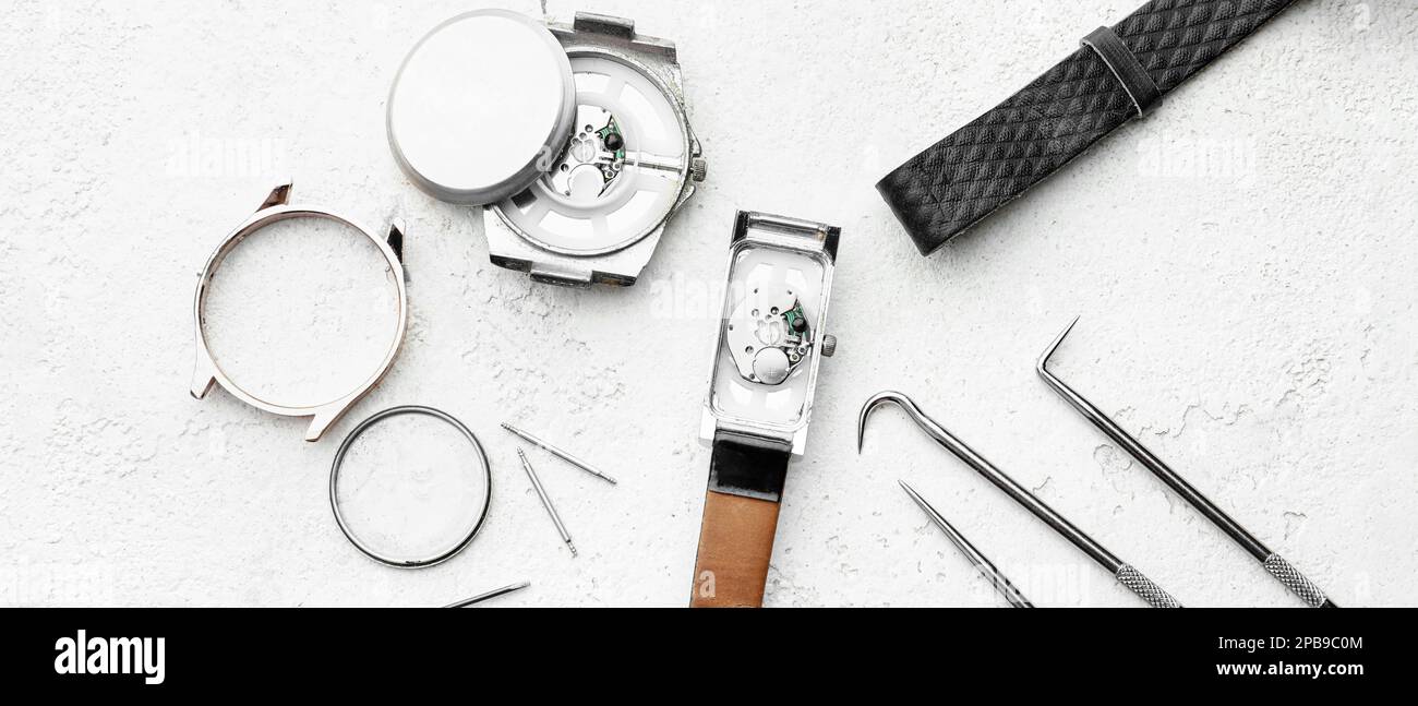 Broken watches and tools for repair on light background Stock Photo Alamy