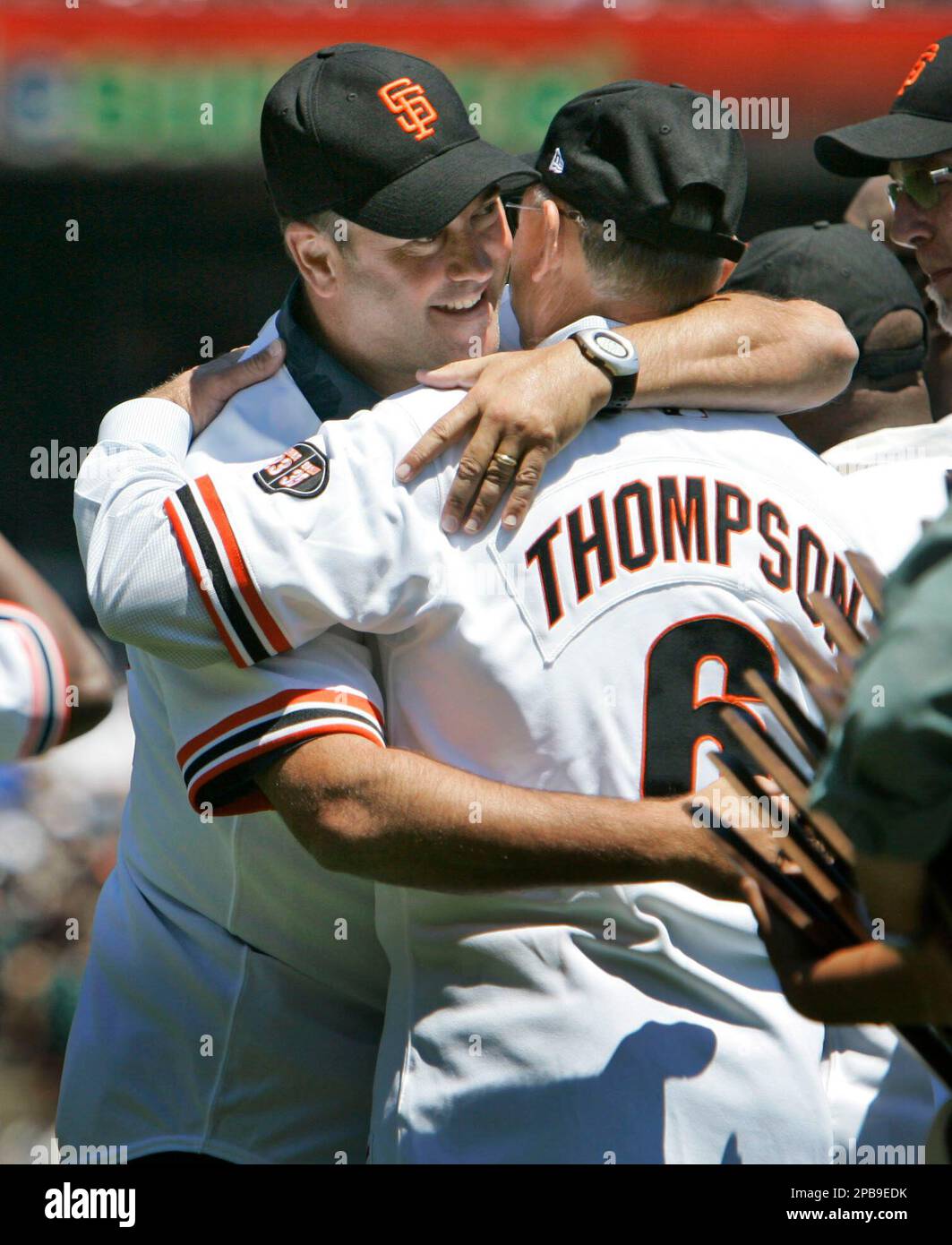 Former San Francisco Giants' Will Clark, left, hugs Robby Thompson as they  take the field as part of a tribute to the Giants' 1987 team before the  baseball game against the Florida
