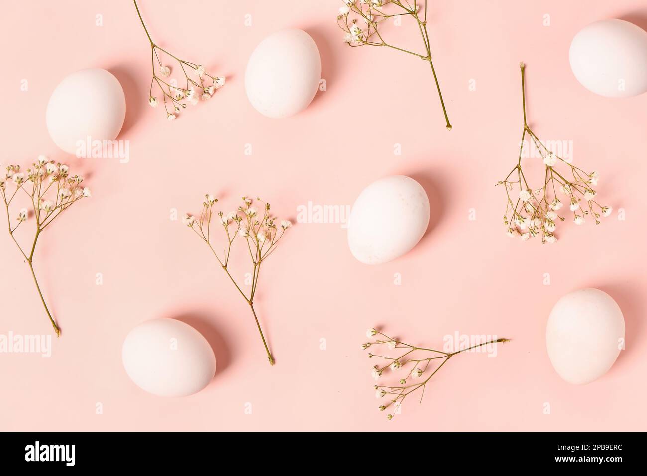 Composition with Easter eggs and gypsophila flowers on pink background ...