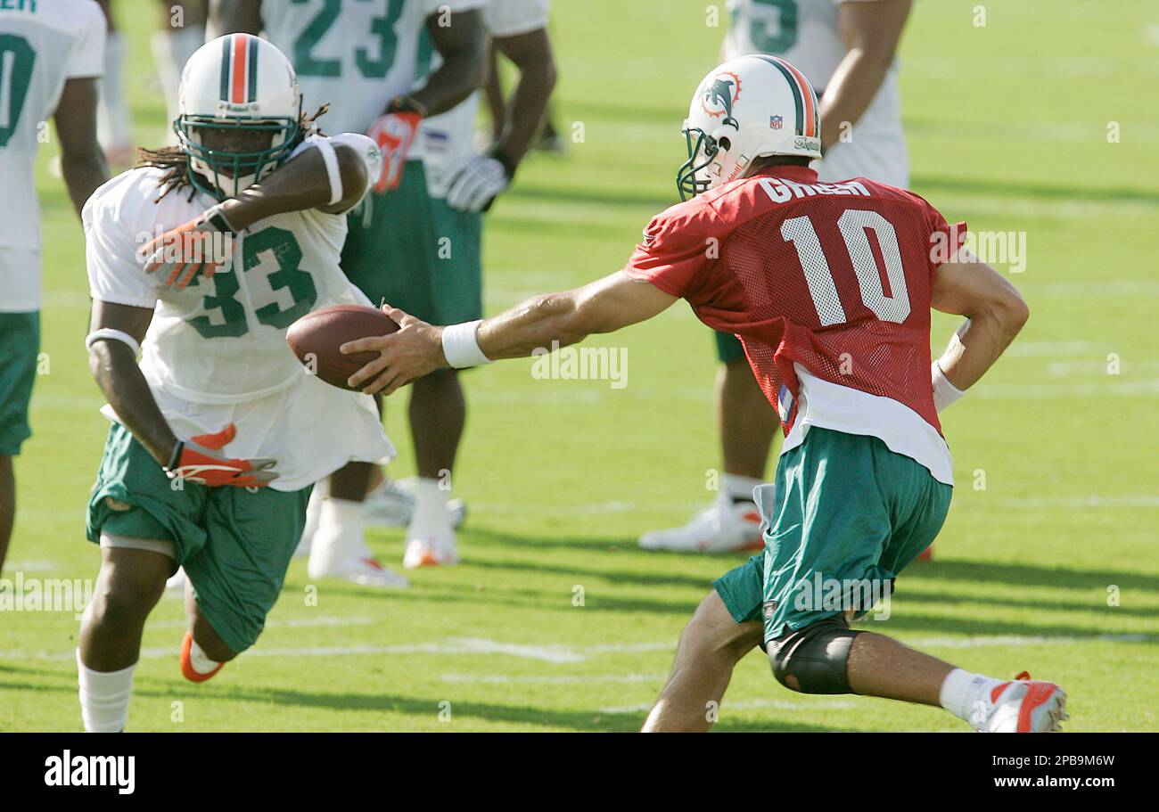 Miami Dolphins quarterback Trent Green (10) hands the football off to  running back Ray Perkins (33) during the first day of the Dolphin's  training camp in Davie, Fla. Saturday, July 28,2 007.(AP