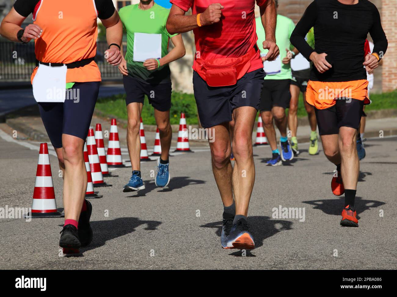 Many Running Races many runners during the marathon on the city streets run in sneakers ...