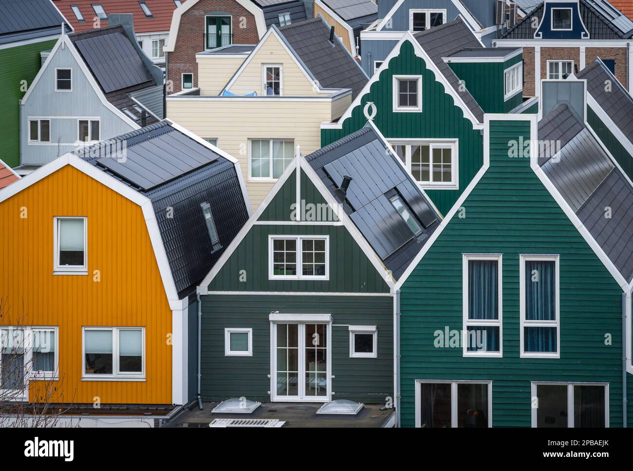 Picturesque dutch houses with wooden facades, rooftops of modern dutch homes with solar panels