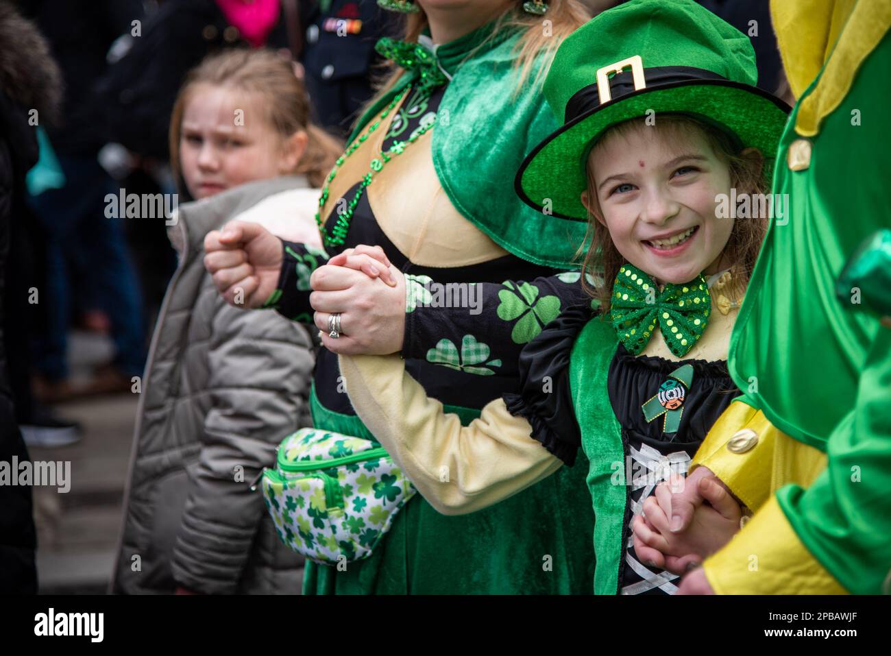 London, UK. 12th Mar, 2023. A young spectator enjoys St Patrick's Day Parade and Festival in Central London. The Mayor's annual shindig has become a highlight of London's cultural calendar, as Londoners and visitors unite in celebrating the great contributions Irish people have made to the city. More than 50,000 people were expected to join the annual procession of Irish marching bands, dance troupes and pageantry. Credit: SOPA Images Limited/Alamy Live News Stock Photo