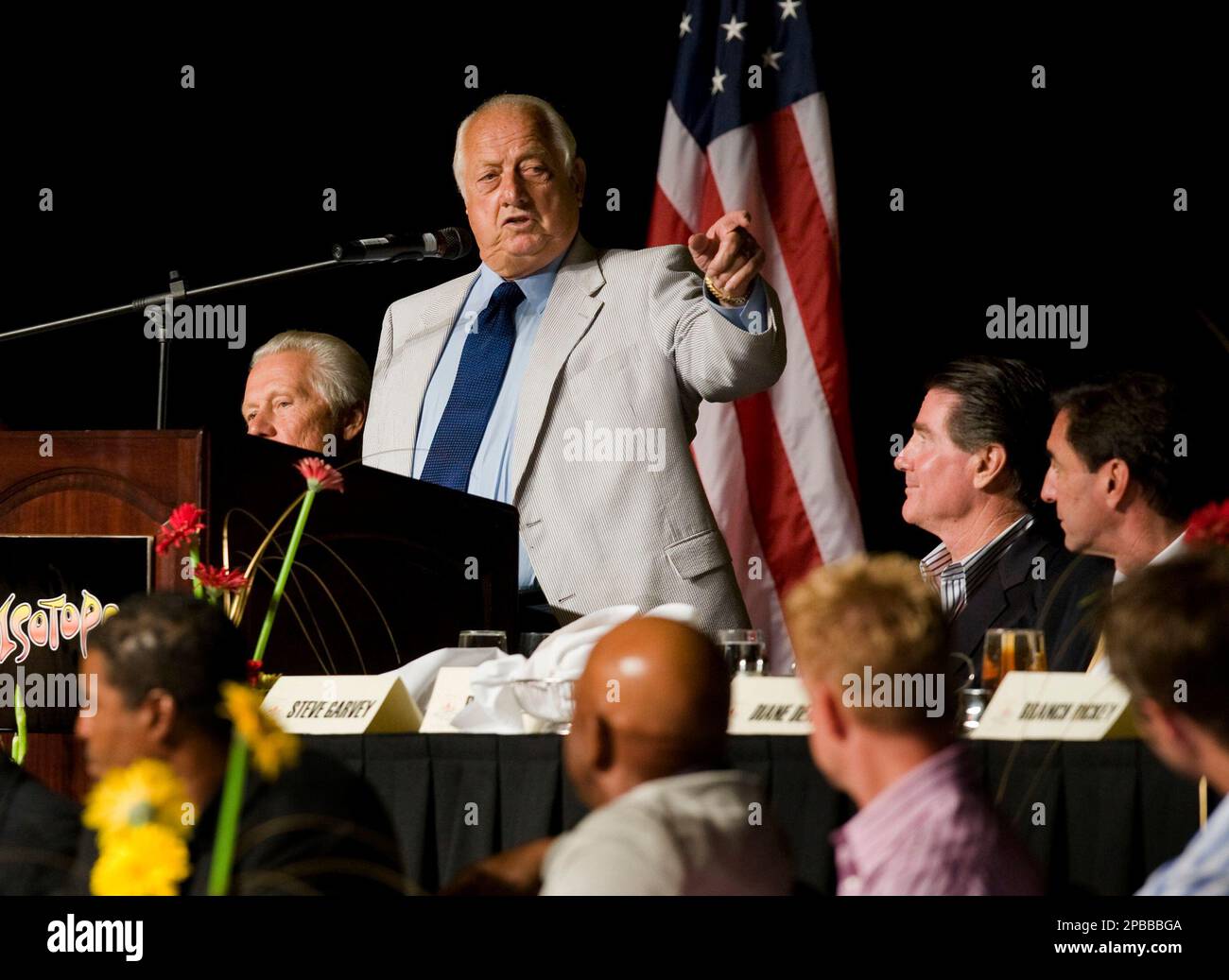 Tommy Lasorda presents Mark Walter (L) with a Dodger jersey as Steve Garvey  presents Irvin Magic Johnson with one as the new owners of the Los  Angeles Dodgers, known as the Guggenheim