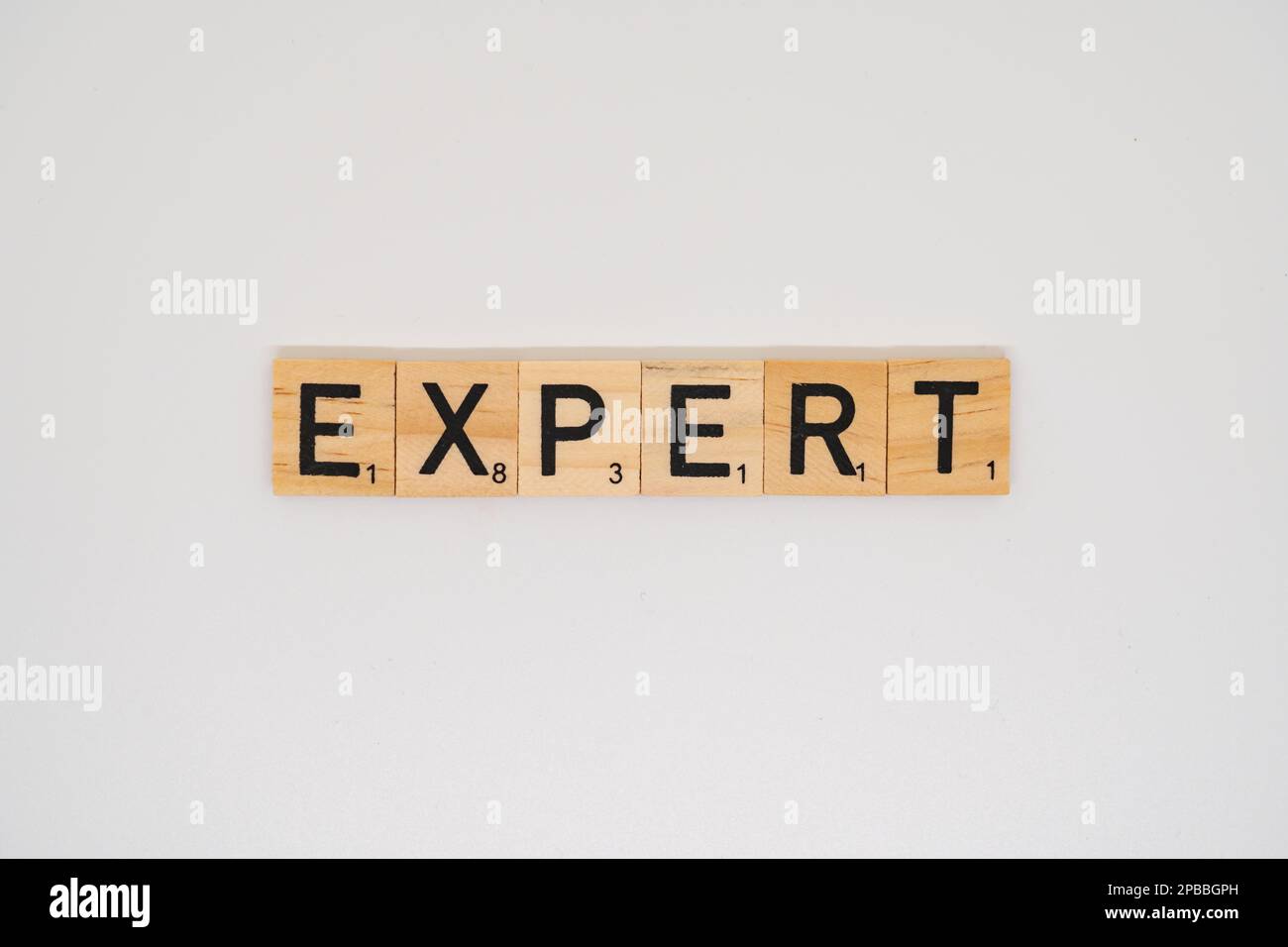 Wooden title spelling the word expert isolated on a white background Stock Photo