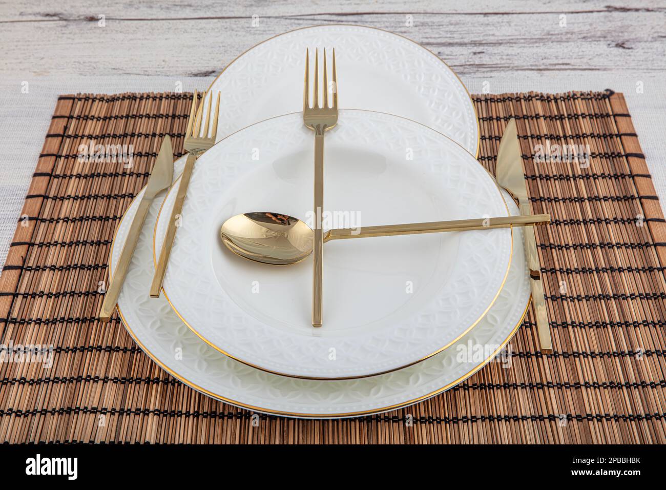Plates and utensils, Plate, Bowl and golden cutlery on wicker american serving on dining table