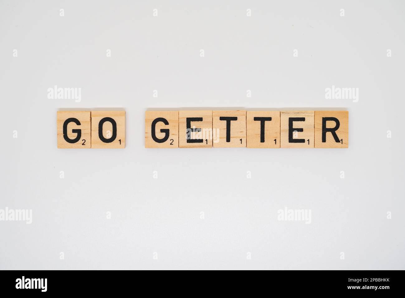 Wooden title spelling the words go getter isolated on a white background Stock Photo Alamy