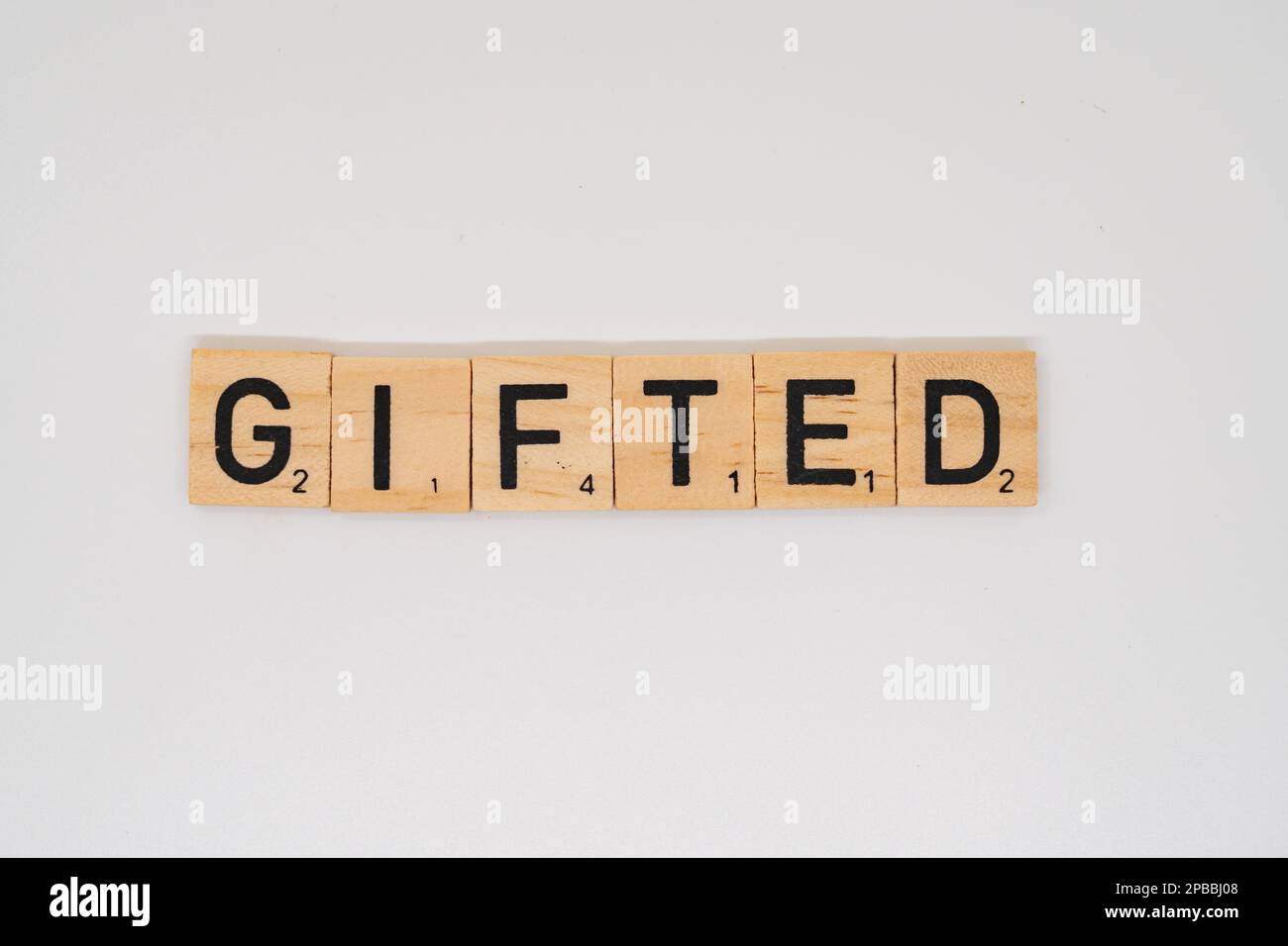 Wooden title spelling the word gifted isolated on a white background Stock Photo